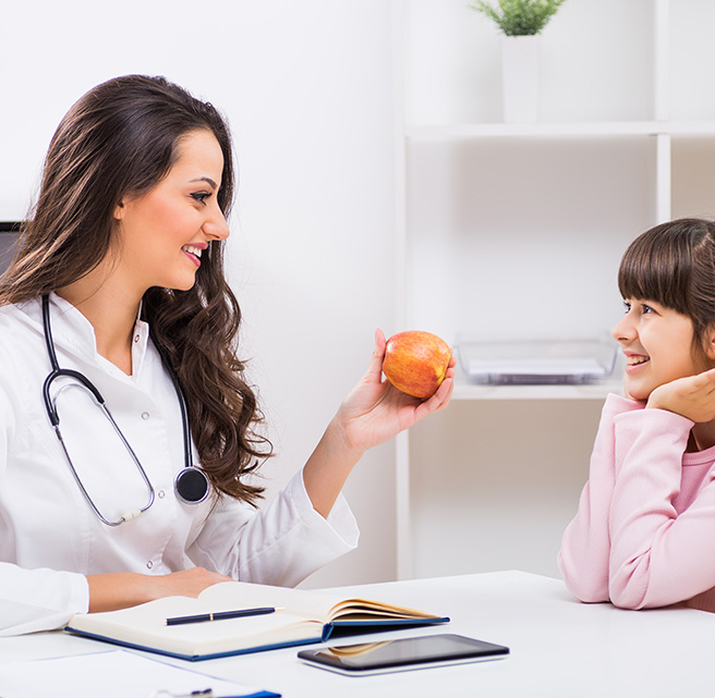 Doctor giving dietary advice to child